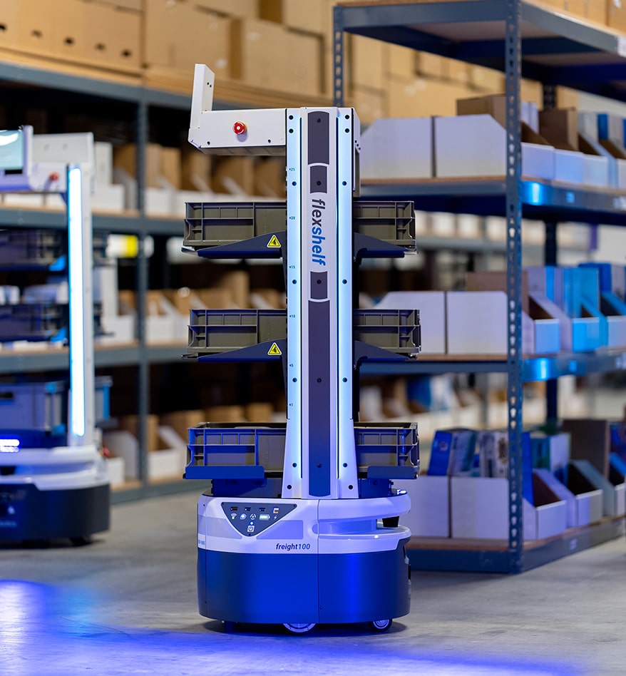Robot AMR Zebra Flex transportant des bacs dans un entrepôt. freight100 visible.