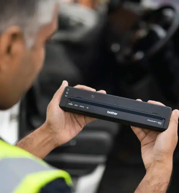 Homme tenant une imprimante mobile Brother PJ883 noire.