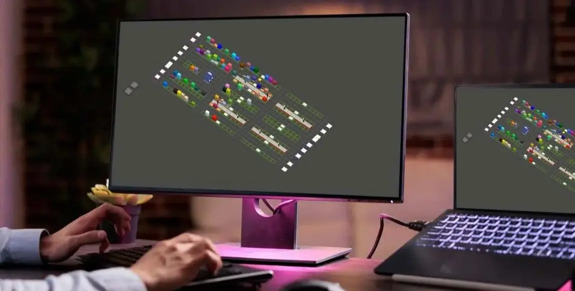 Plan d'entrepôt "pallet to person" affiché sur deux écrans d'ordinateur.