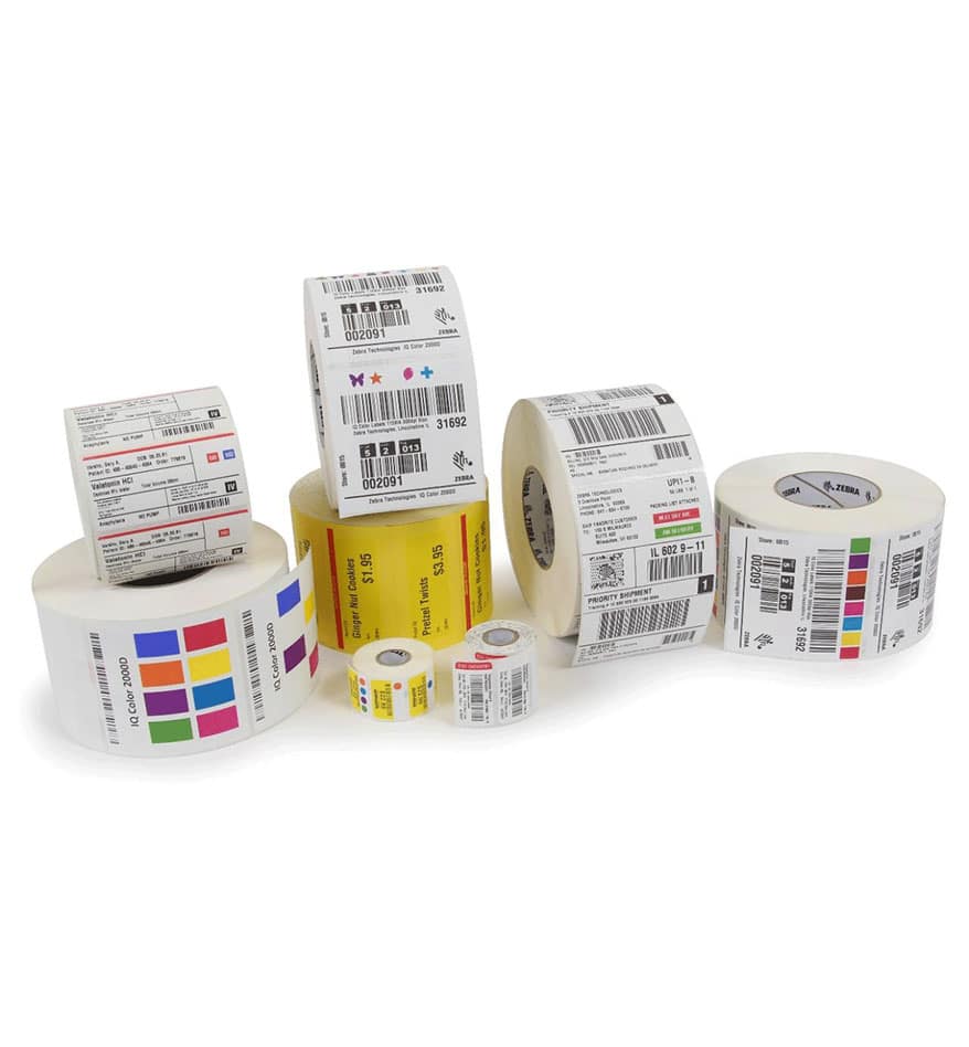 Rouleaux d'étiquettes papier variés, certains avec codes-barres et logos Zebra.