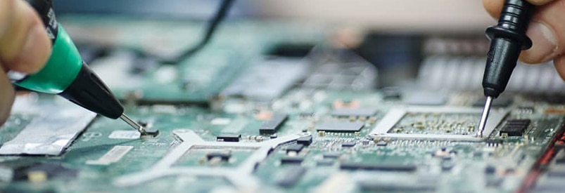 Laptop motherboard repair in progress, close-up view.